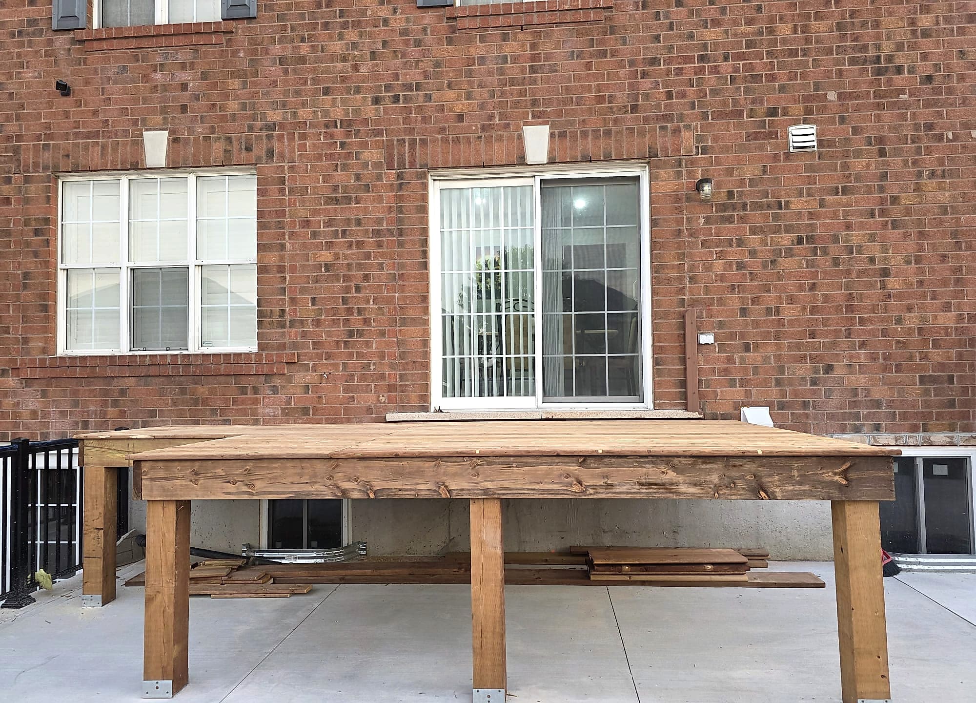 Pressure-treated deck platform framed on posts and fully decked, photographed before railing installation